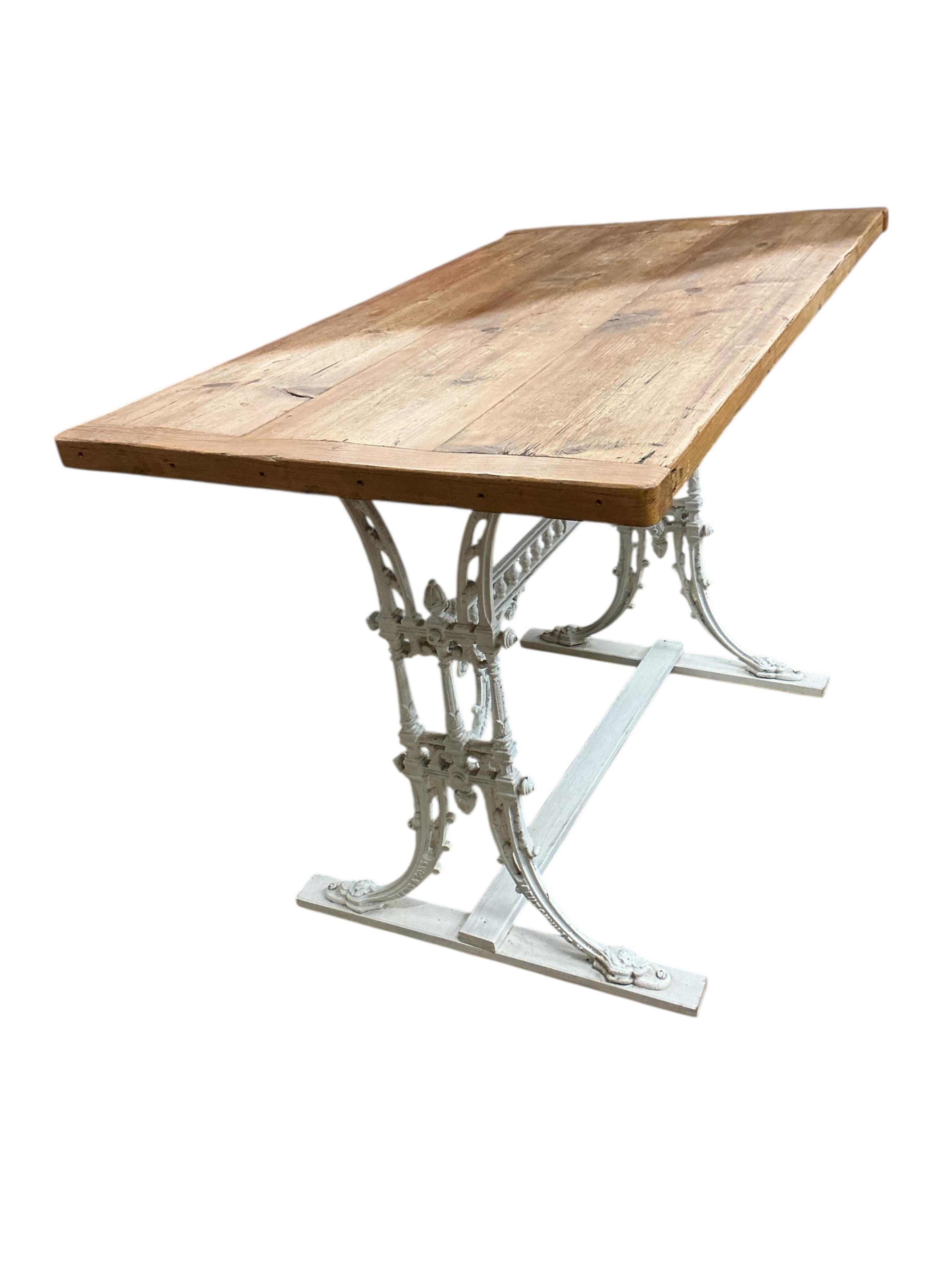 A Victorian painted cast iron table with rectangular pine top, width 110cm, depth 63cm, height 75cm